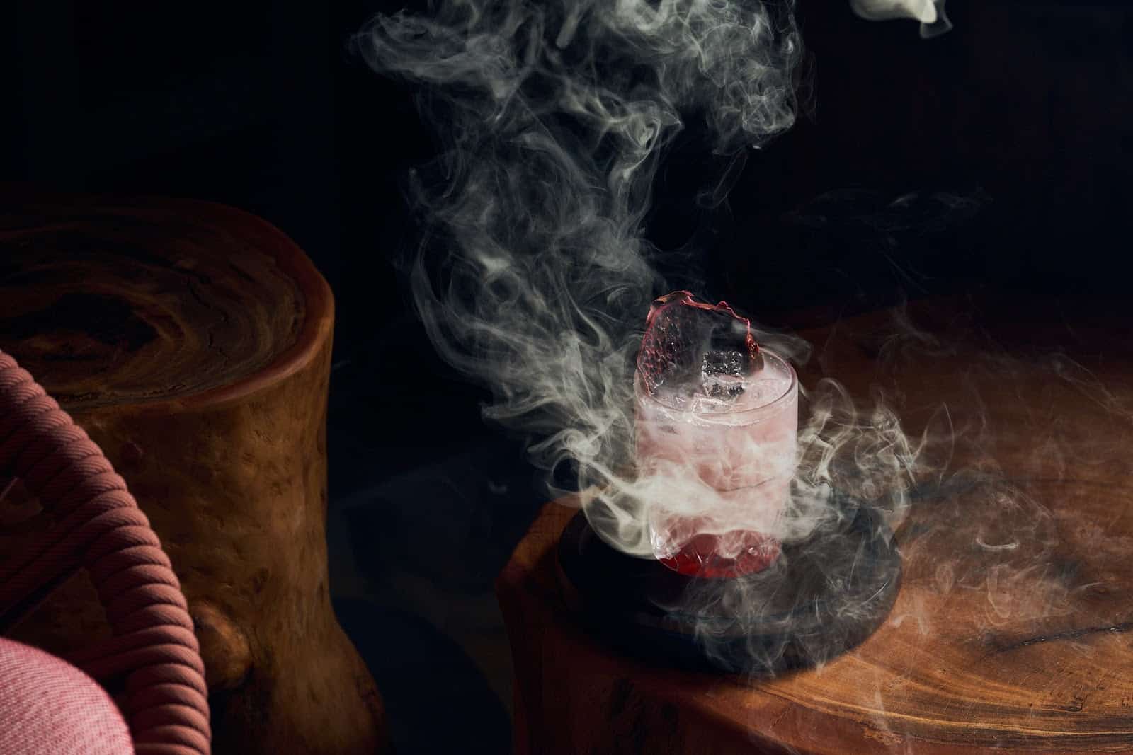 A smoky craft cocktail at Nubé Rooftop in Fort Lauderdale, styled with dramatic vapor for a spooky and elegant Halloween atmosphere.